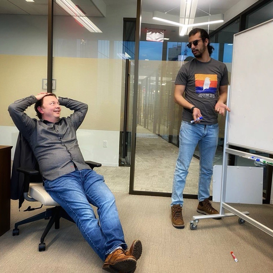 Ben Moataz leading a working session beside a whiteboard